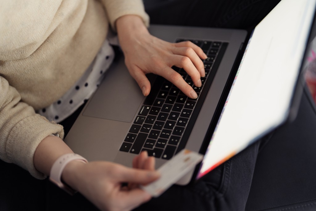 online-shopping-using-card-laptop-woman-handsusing-technology-shop-while-sitting-sofa-indoors.jpg